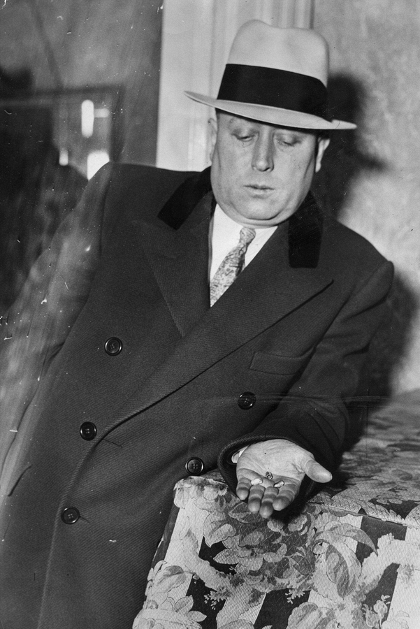 1933-03-24 Chief County Detective, Harry B Crook, holding slugs taken from the body of Al Lillien.jpg