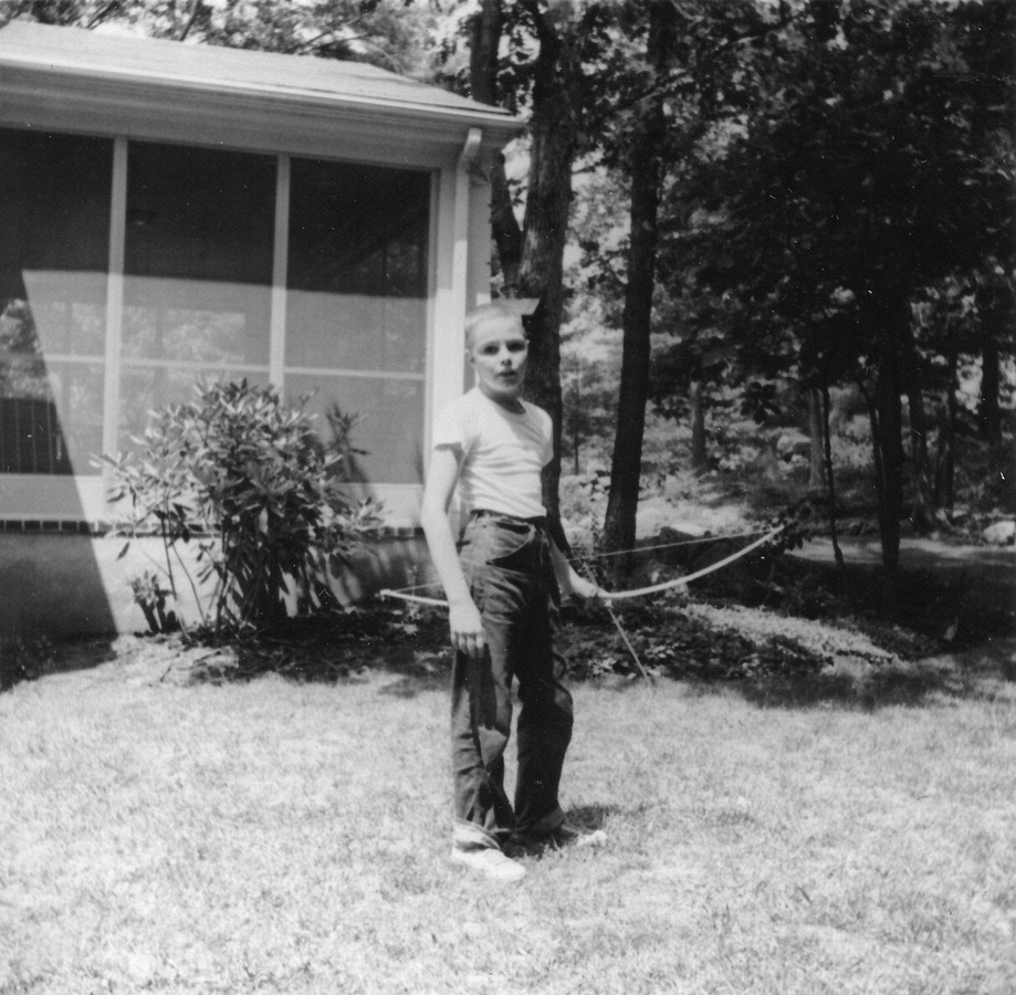 1961-08-01~ 1 Pete Jr practicing archery in back yard, 26 Driftwood Ln, Weston MA.jpg