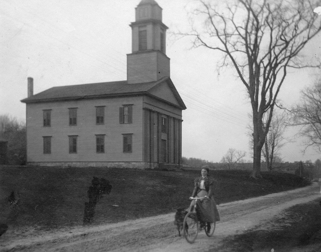 1902~ Jennie on wheel, Congregational Church, Bethany CT.jpg